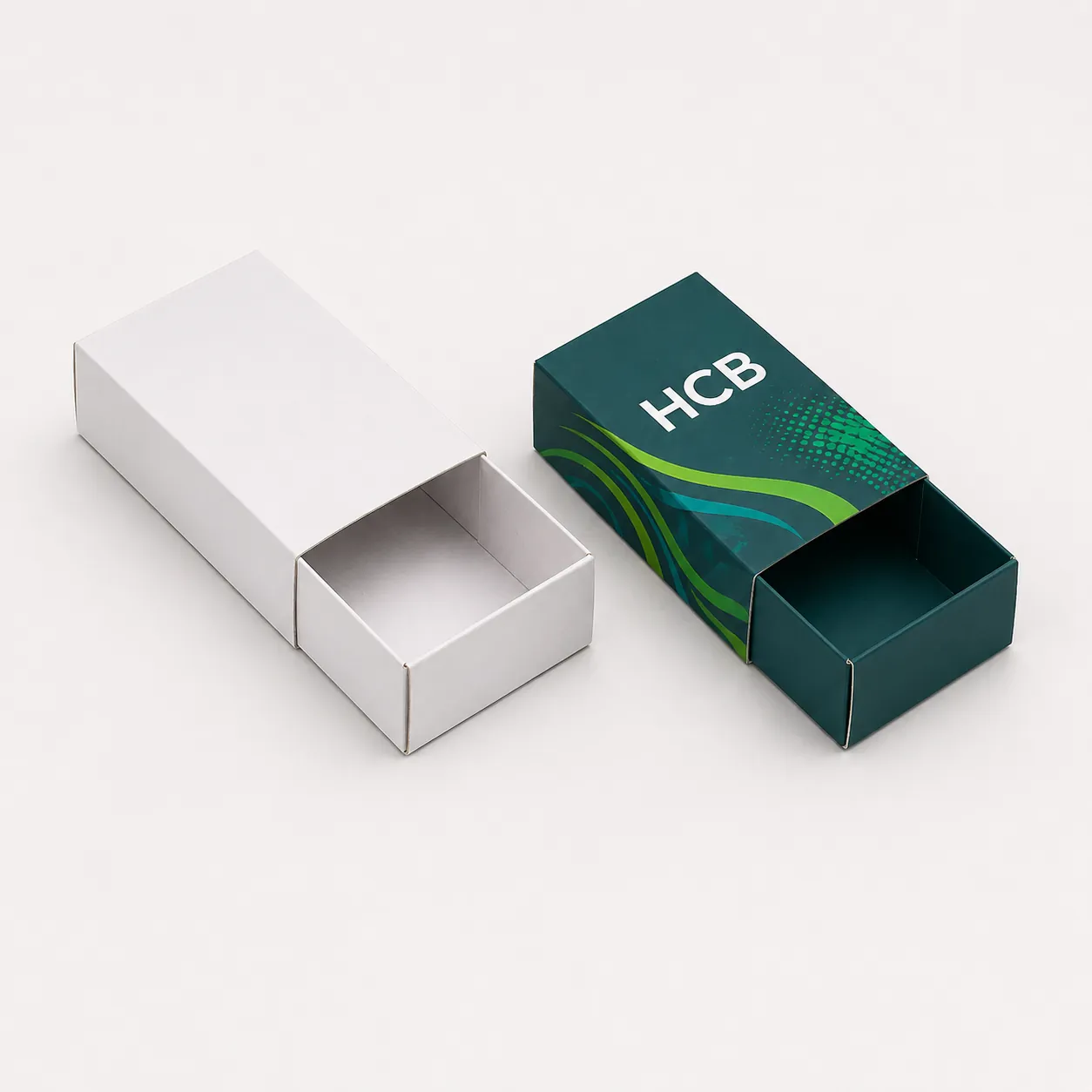 Sliding sleeve cardboard boxes in white and teal branded designs. class=